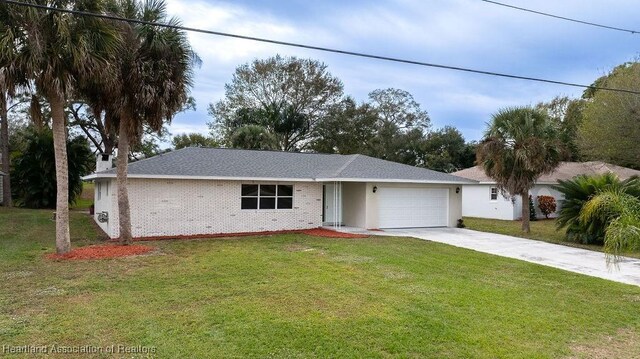 single story home with a garage and a front yard