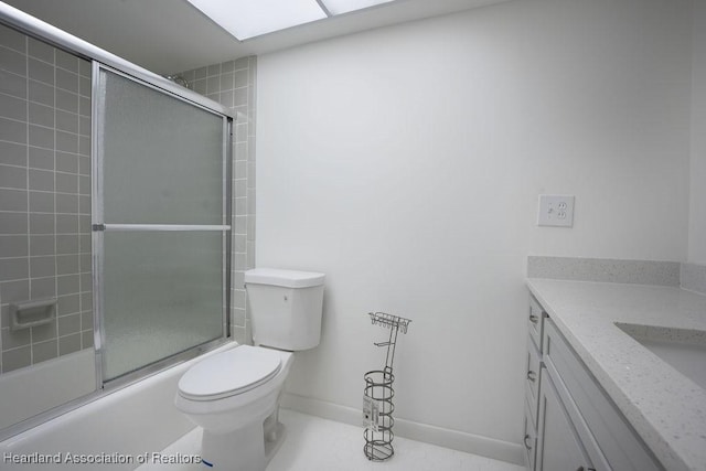 full bathroom with tile patterned floors, bath / shower combo with glass door, toilet, and vanity