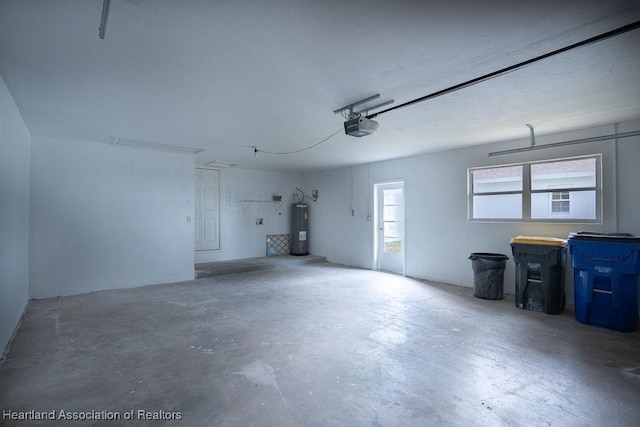 garage with a garage door opener and electric water heater