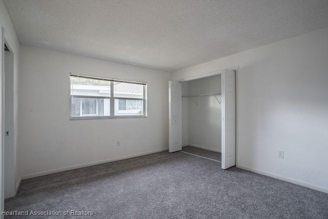 unfurnished bedroom with carpet, a closet, and a textured ceiling