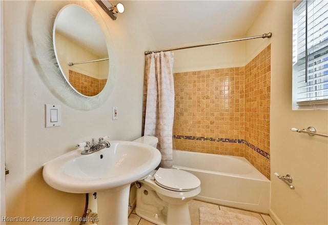 bathroom featuring shower / bath combination with curtain, tile patterned floors, and toilet