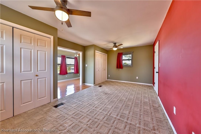 empty room featuring light carpet and ceiling fan