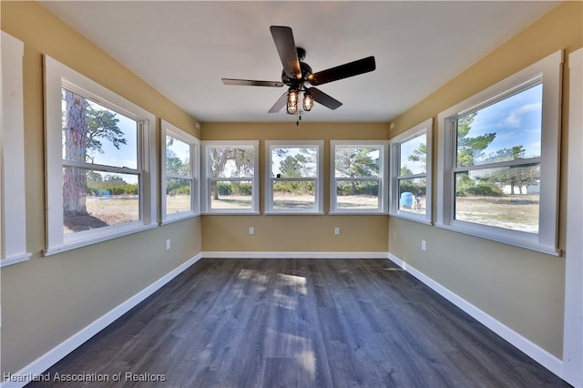 unfurnished sunroom featuring ceiling fan