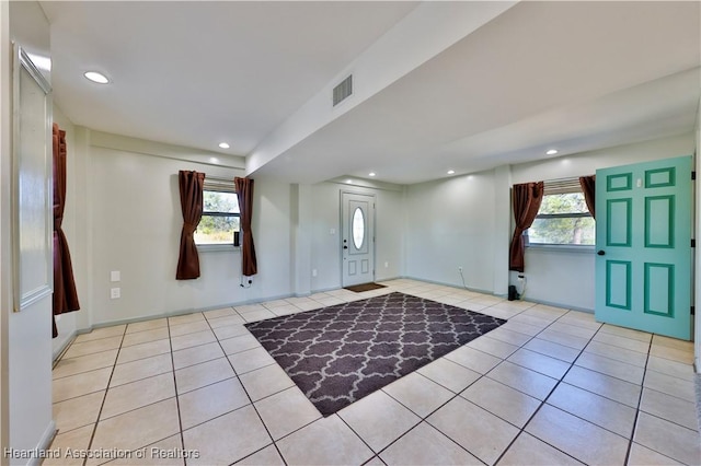 foyer with a wealth of natural light and light tile patterned floors