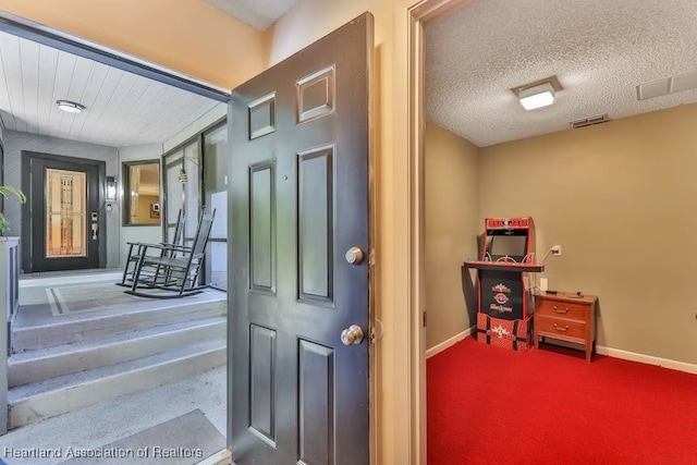 foyer featuring a textured ceiling