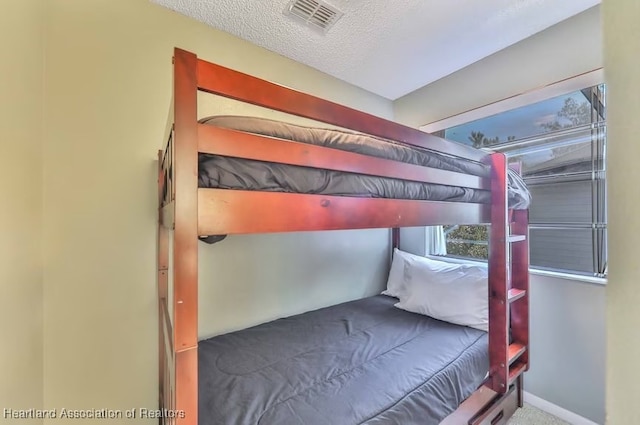 unfurnished bedroom with a textured ceiling