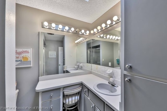 bathroom featuring vanity and a textured ceiling