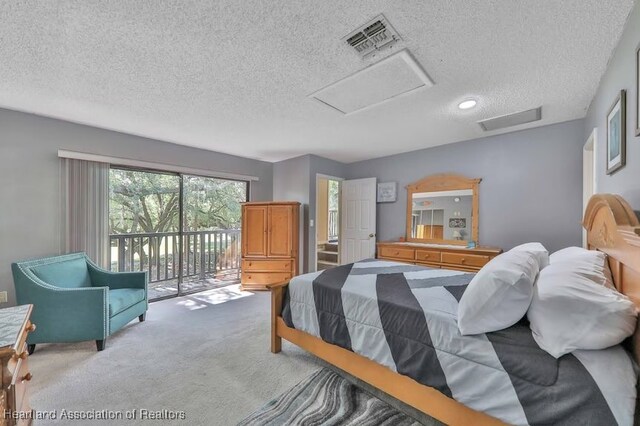 carpeted bedroom with access to outside and a textured ceiling