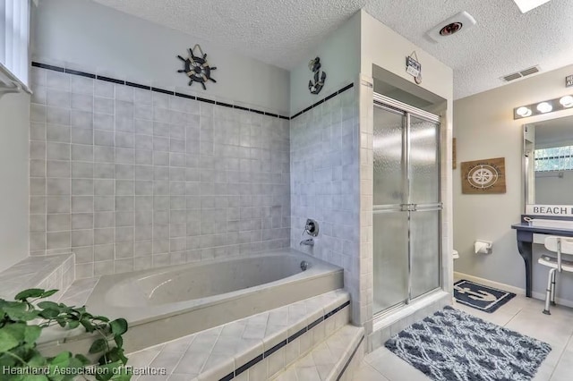 bathroom featuring tile patterned flooring, plus walk in shower, and a textured ceiling