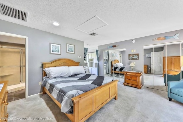 bedroom featuring carpet flooring, a closet, and a textured ceiling