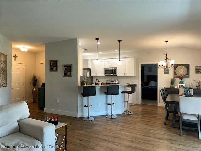 living room featuring a chandelier, baseboards, dark wood-style floors, and recessed lighting