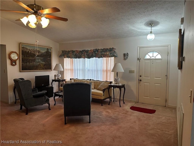 living room featuring lofted ceiling, ceiling fan, carpet, and a wealth of natural light