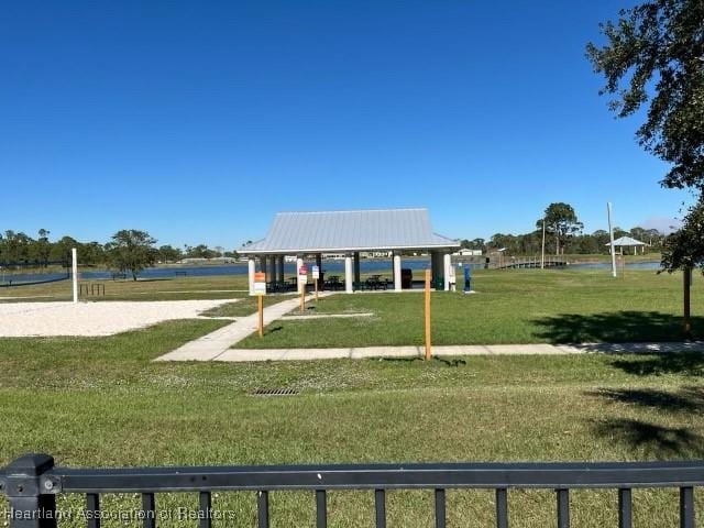 view of home's community featuring a water view, a gazebo, a lawn, and volleyball court