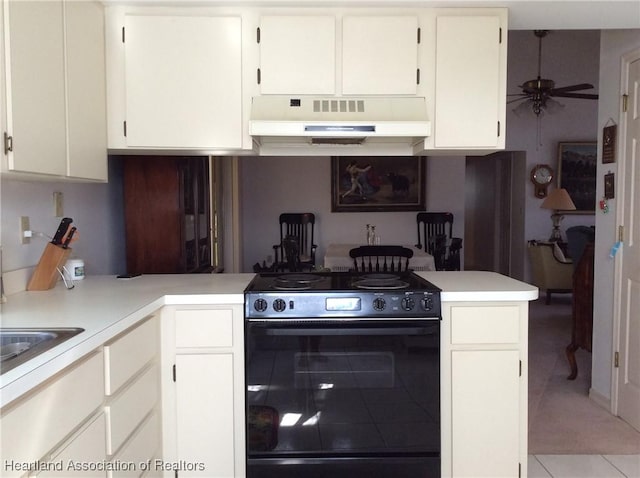 kitchen with black range oven, white cabinetry, kitchen peninsula, light tile patterned flooring, and ceiling fan