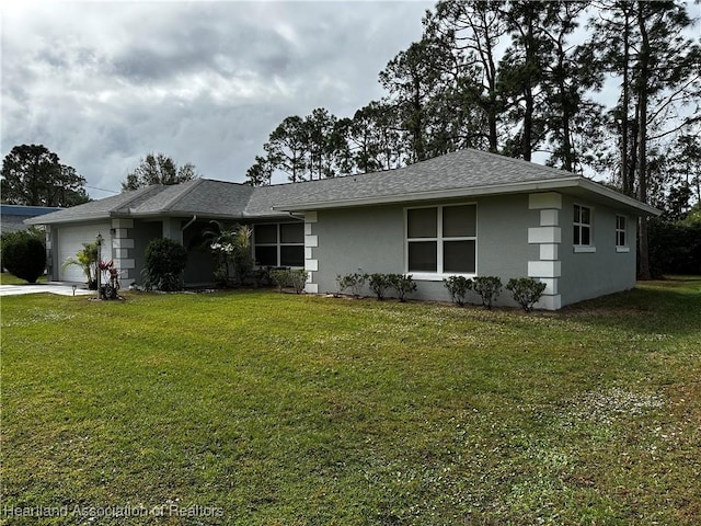 single story home featuring a garage and a front yard