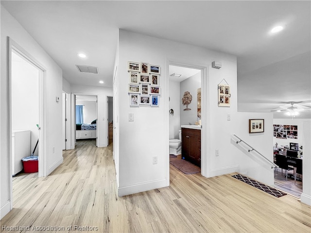 corridor with light hardwood / wood-style floors