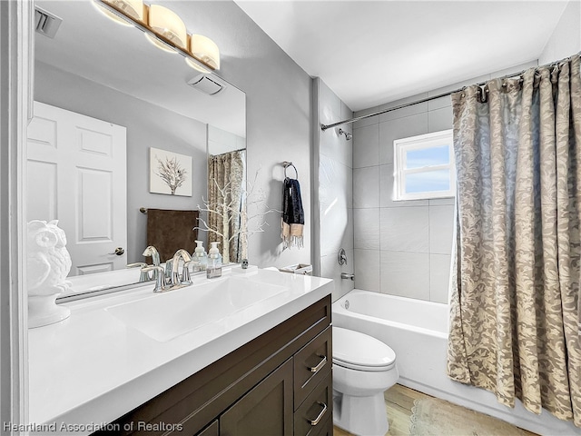 full bathroom with vanity, toilet, and shower / bath combo with shower curtain