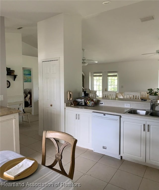 2010 W Royalton Rd, Avon Park, FL 33825 - kitchen with white dishwasher, a ceiling fan, light tile patterned floors, white cabinetry, and vaulted ceiling
