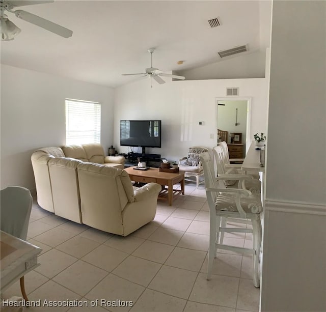 2010 W Royalton Rd, Avon Park, FL 33825 - living room with a ceiling fan, light tile patterned flooring, and vaulted ceiling