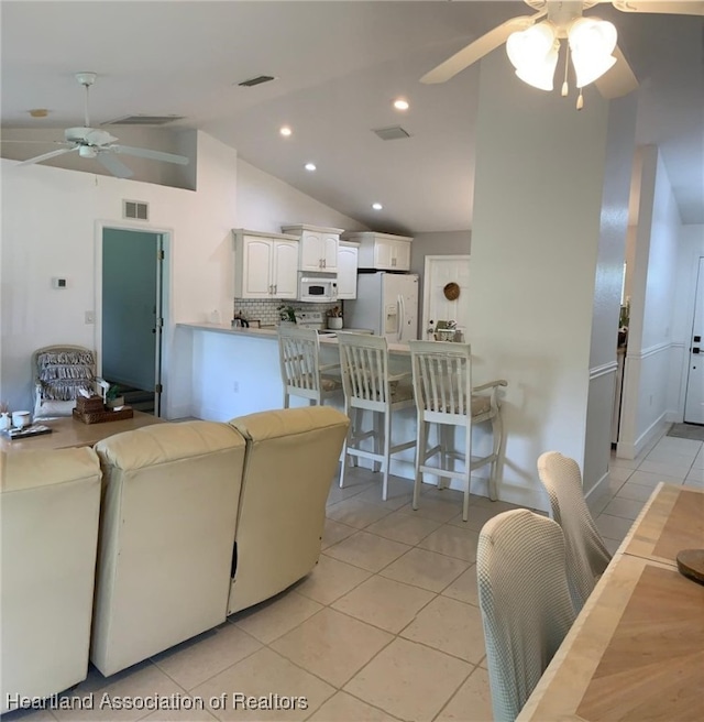 2010 W Royalton Rd, Avon Park, FL 33825 - living room featuring a ceiling fan, vaulted ceiling, light tile patterned floors, and recessed lighting