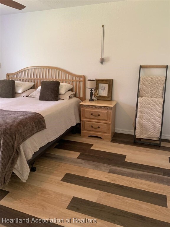 2010 W Royalton Rd, Avon Park, FL 33825 - bedroom featuring wood finished floors and baseboards