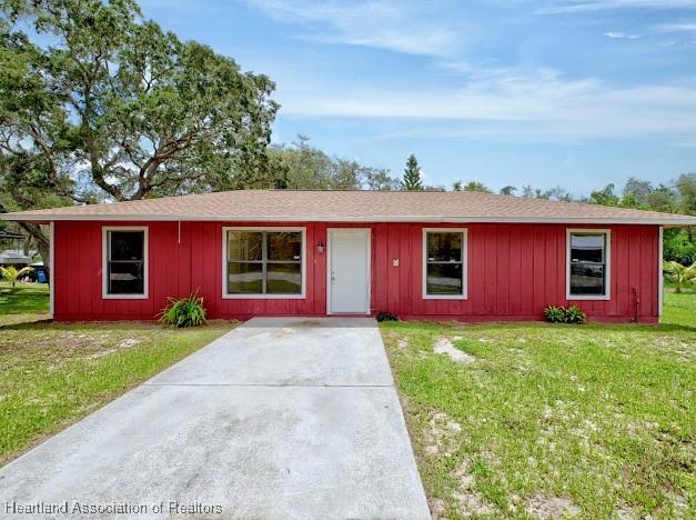1916 Melady Ave, Sebring, FL 33870 - single story home with a front yard and board and batten siding