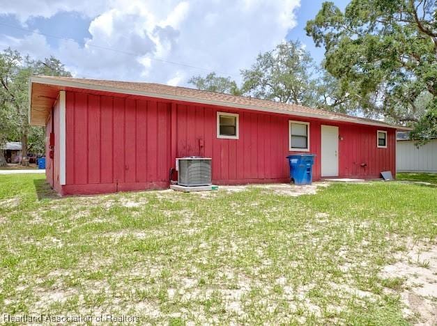 1916 Melady Ave, Sebring, FL 33870 - rear view of property with a yard and board and batten siding