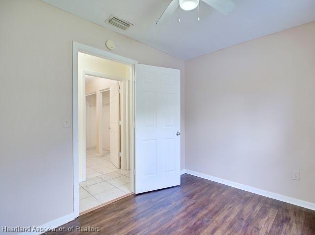 1916 Melady Ave, Sebring, FL 33870 - unfurnished bedroom featuring wood finished floors, a ceiling fan, and lofted ceiling