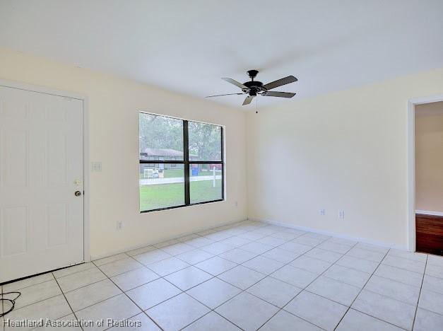1916 Melady Ave, Sebring, FL 33870 - empty room with a ceiling fan and light tile patterned floors