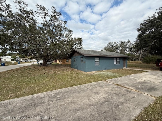 view of side of home with a yard