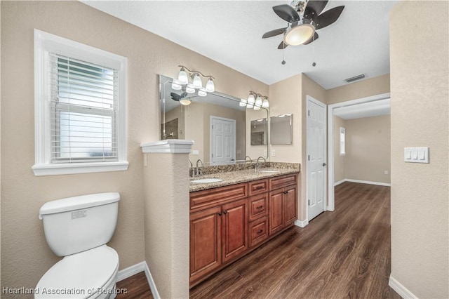 bathroom with vanity, ceiling fan, hardwood / wood-style flooring, and toilet