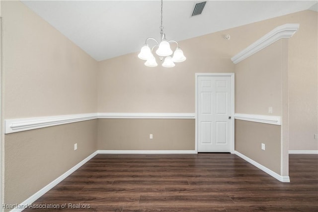 spare room featuring lofted ceiling, dark hardwood / wood-style flooring, and a notable chandelier