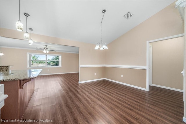 interior space with ceiling fan with notable chandelier, vaulted ceiling, and dark hardwood / wood-style floors