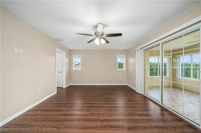 unfurnished room with dark wood-type flooring and ceiling fan