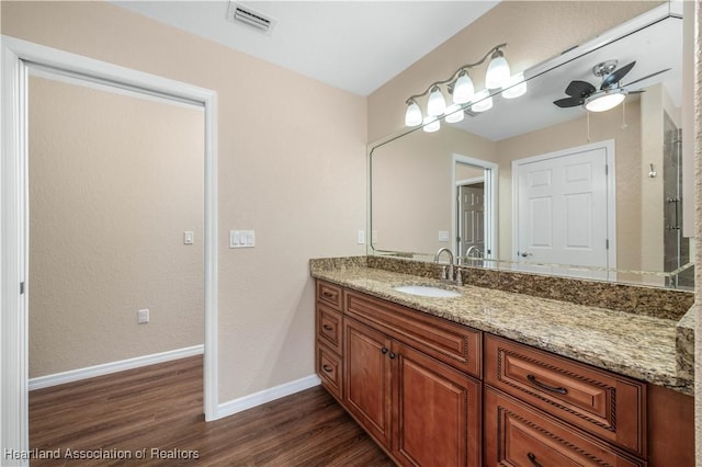 bathroom with vanity, hardwood / wood-style flooring, and ceiling fan