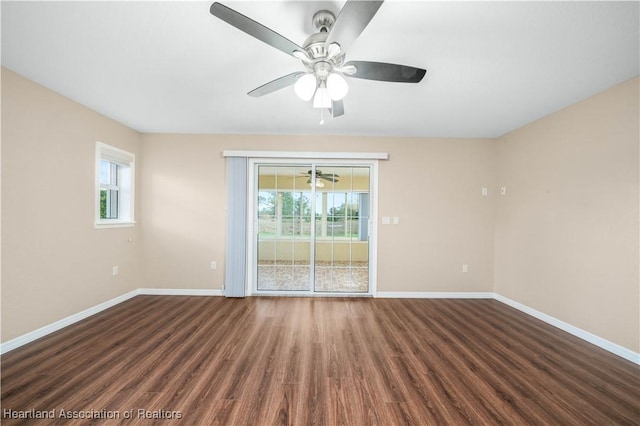 spare room featuring dark hardwood / wood-style flooring and ceiling fan