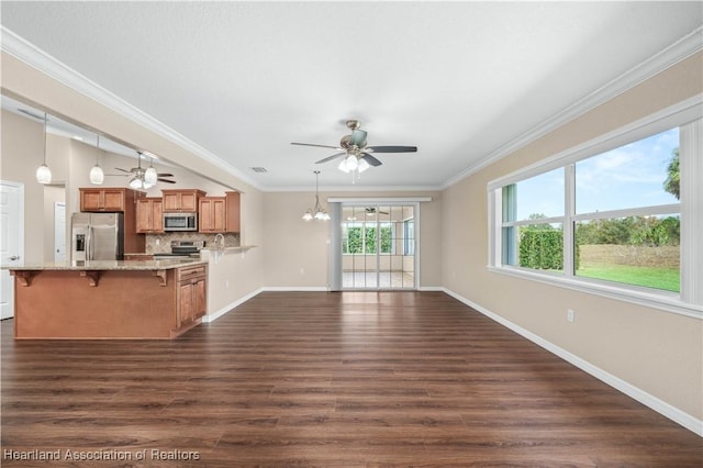 unfurnished living room with crown molding, lofted ceiling, ceiling fan with notable chandelier, and dark wood-type flooring