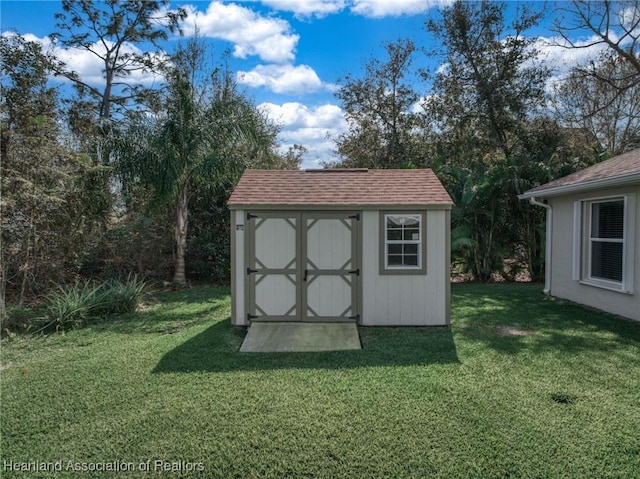 view of outbuilding featuring a yard