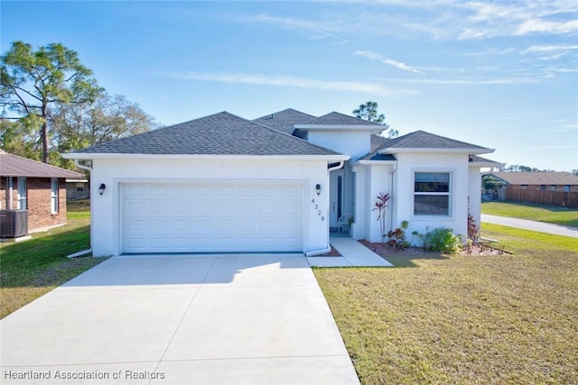 view of front of property with cooling unit, a garage, and a front lawn