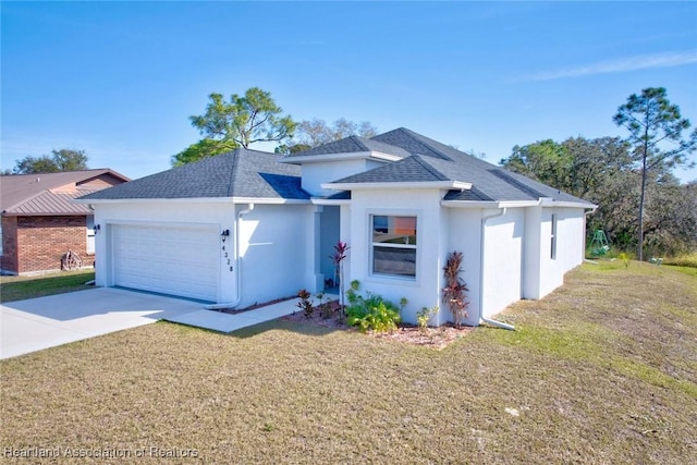 view of front of home featuring a garage and a front yard