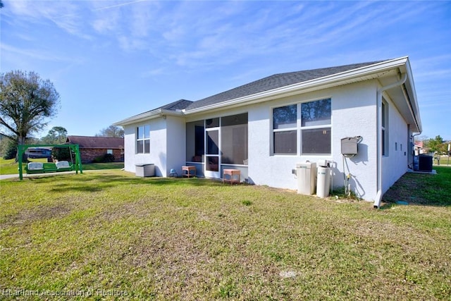 rear view of property with a yard