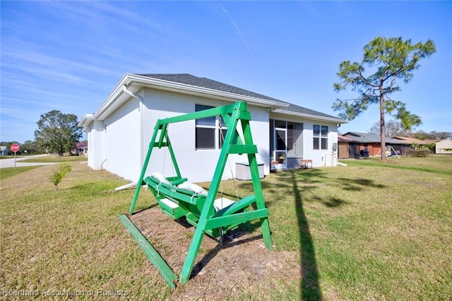 rear view of house featuring a yard