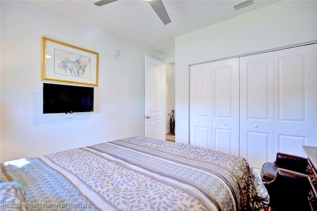 bedroom with ceiling fan and a closet