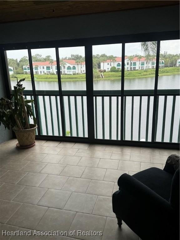 sunroom / solarium with a water view