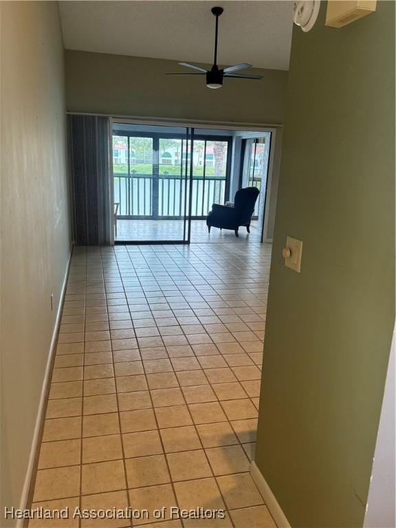 interior space featuring ceiling fan and light tile patterned floors