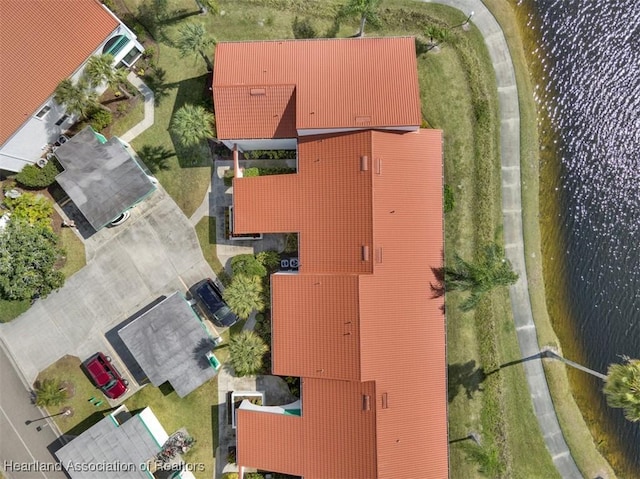 birds eye view of property with a water view