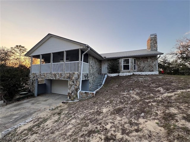 view of front of house featuring a garage and a sunroom