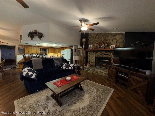 living room with dark wood-type flooring, a fireplace, and ceiling fan