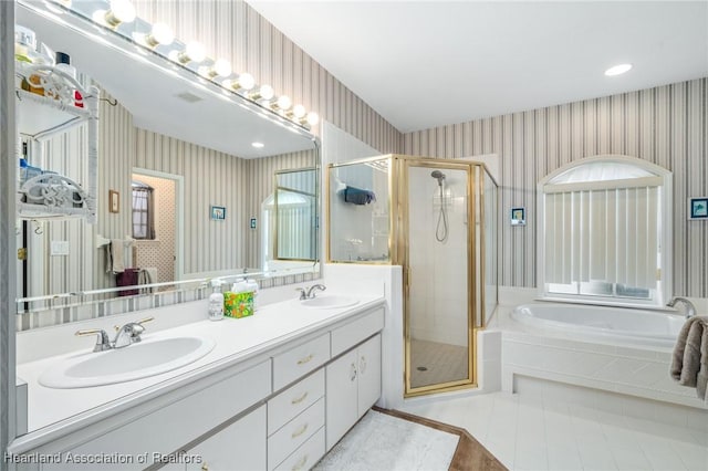 bathroom featuring shower with separate bathtub and vanity