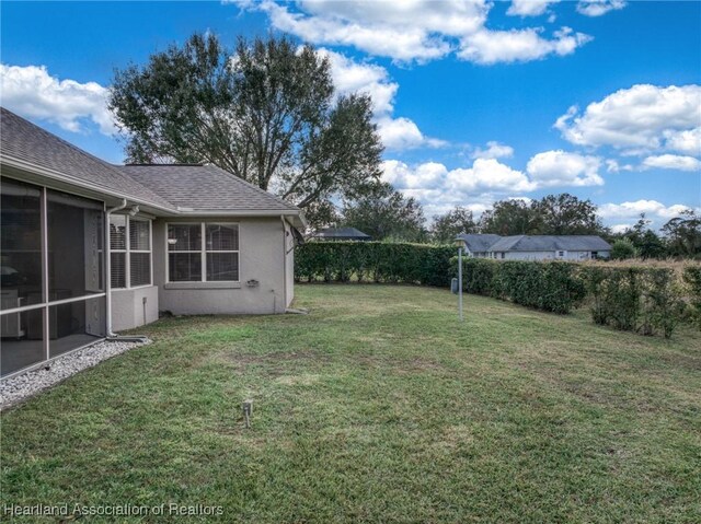 view of yard with a sunroom